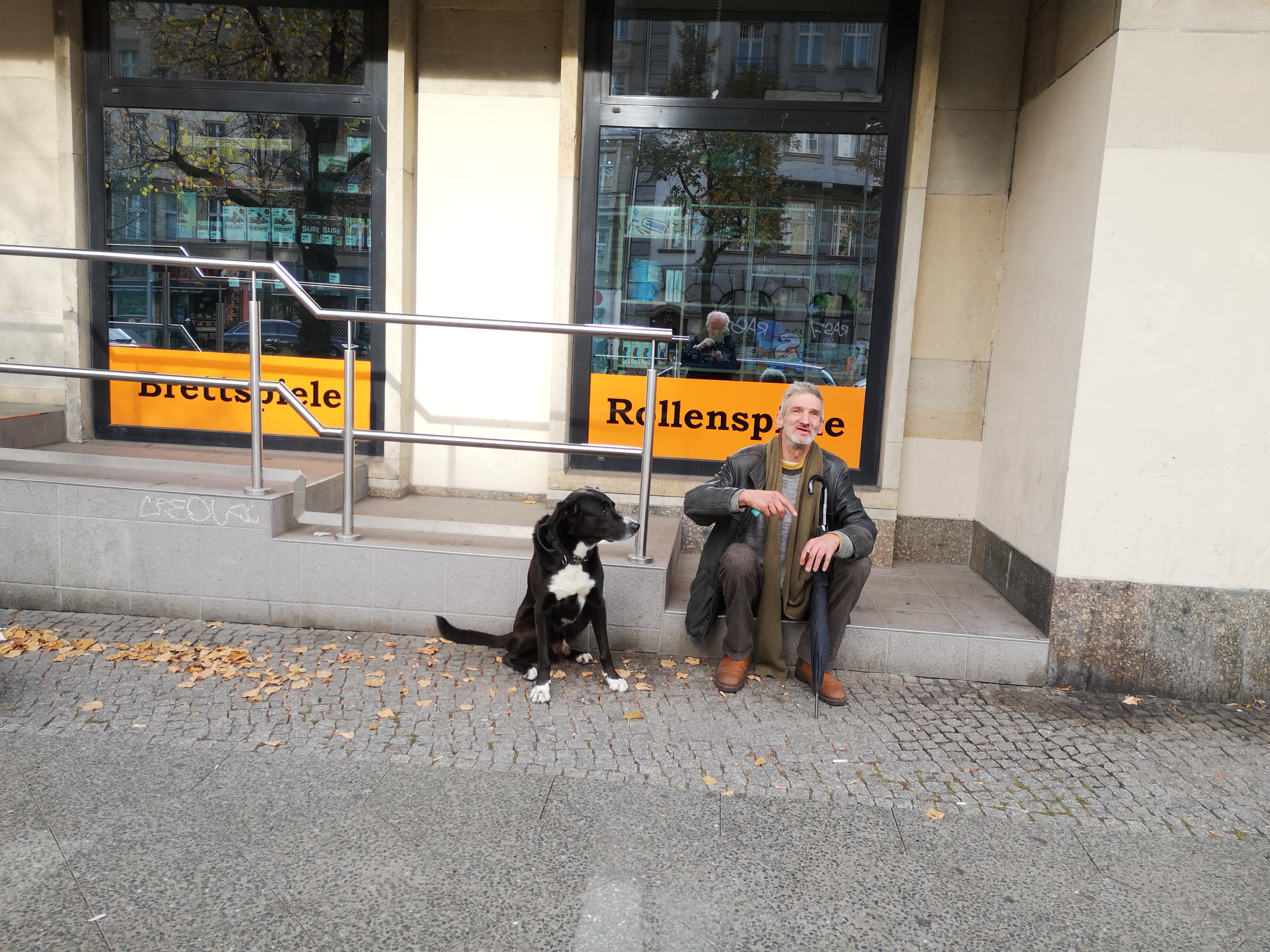 Farbfoto von einem Hund und seinem Mensch in der Frankfurter Allee in Friedrichshain. Im Oktober 2024. Fotograf: Erwin Thomasius.